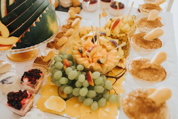 istock Beautifully arranged table with fresh fruits and desserts 2182075449