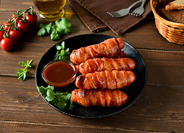 istock Bacon wrapped sausages with barbecue sauce 2182077587