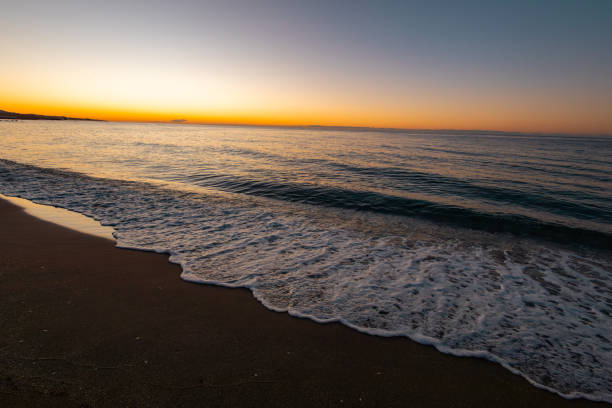 beautiful sunrise on the sea with white waves