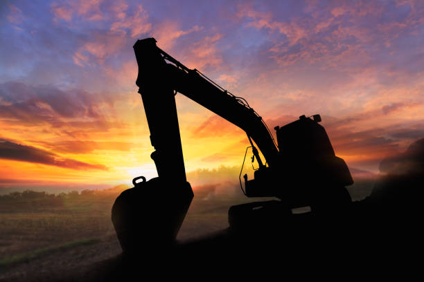 istock Crawler excavator  silhouette are digging the soil in the construction site 2182080382