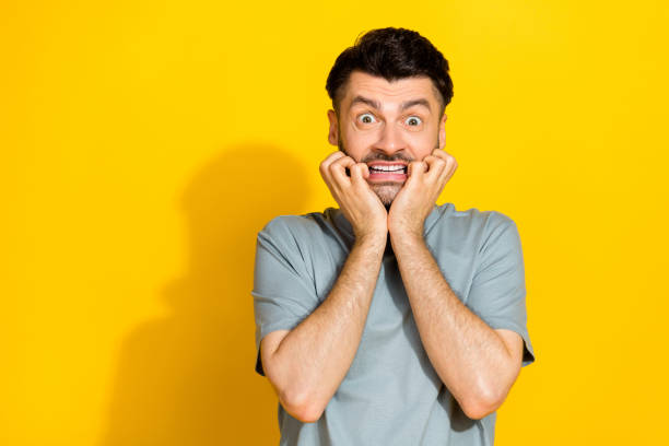 istock Closeup photo of young nervous man bite fingers problems deadline work manager crazy unexpected empty space isolated on yellow color background 2182084298