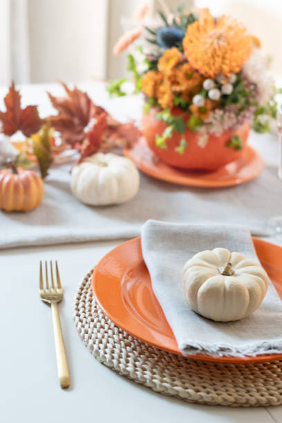 istock Thanksgiving day table setting with fall decorations of flowers and pumpkins. 2182086408