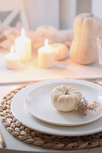 istock Thanksgiving day table setting with fall decorations of flowers and pumpkin. 2182086411