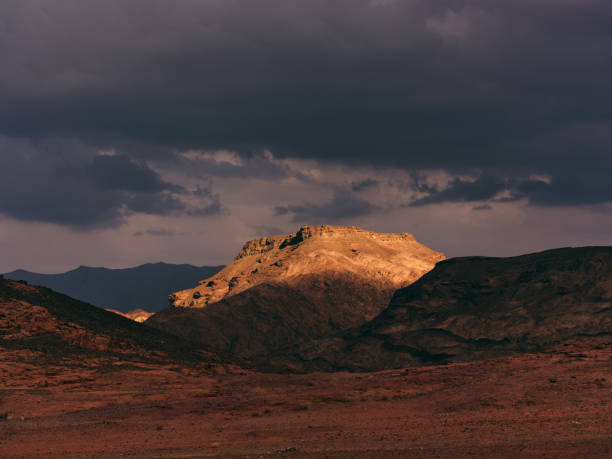 View of sun lightening part of the mountain in the desert. Photographed in medium format.