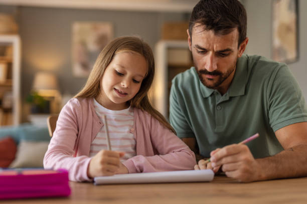 istock Caring Young Dad Helping Daughter Preparing School Homework 2182089387