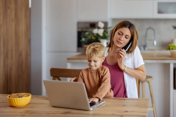 istock Mother Discussing Work Issues While Looking After Her Child at Home 2182089750