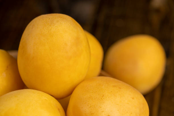 ripe apricots on the table, ripe soft apricot fruits on the cutting board
