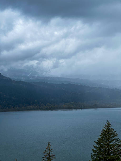 istock Stormy View Over River and Forested Hills 2182089828