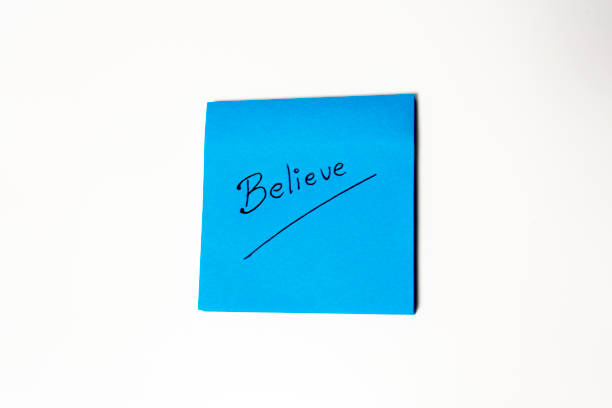 istock Blue note paper with the word Believe on it isolated on white background 2182089867