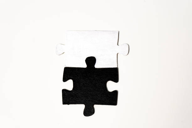 Black and white puzzle pieces isolated on white background. Top view.