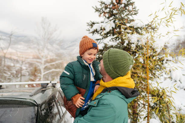 Photo of father and son having precious moments on a snowy day