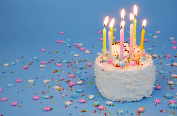 istock Birthday cake with burning candles on blue background 2182091934