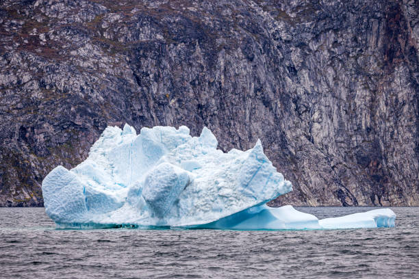 istock Iceberg in front on a barren rock wall 2182093472