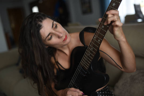 istock Woman at home playing and learning electric guitar 2182095587