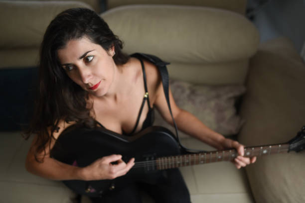 istock Woman at home playing and learning electric guitar 2182095623
