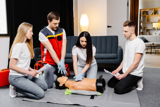 istock Group of people learning how to make first aid heart compressions with dummies during the training indoors 2182096335