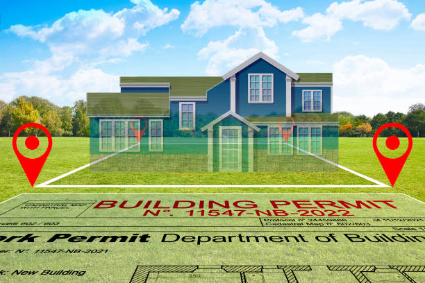 istock BUILDING PERMIT CONCEPT with vacant land available for building construction and work permit for residential building project and American style residential home 2182099666