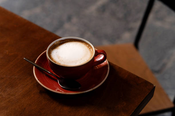 istock Top view of ceramic cup with cappuccino on the table 2182103880