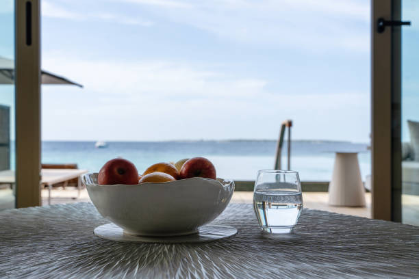 istock Scenic Ocean View from Indoor Table with Fresh Fruit and Water 2182106191
