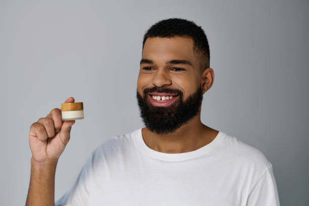 istock A young man happily embraces his daily skincare routine in a bright, modern bathroom setting 2182106370