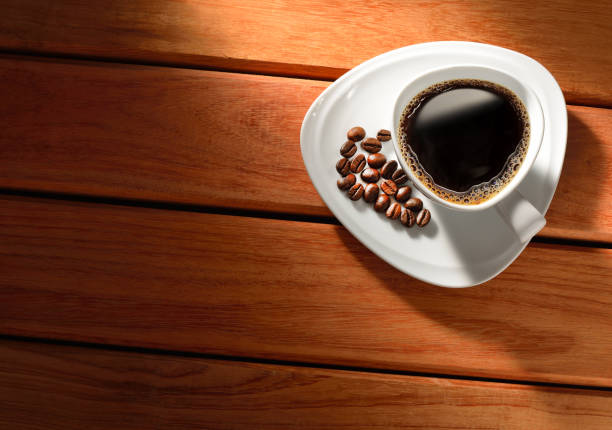 istock Coffee cup and coffee beans on old wooden table 2182108354