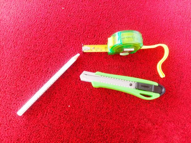 cutting tweezers and pencil \nwhite on the red carpet