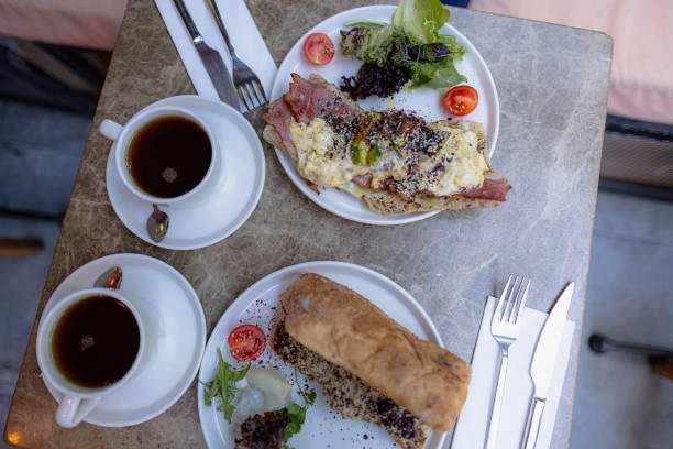 istock Brunch plates at a restaurant, fork and knife in hands 2182113103
