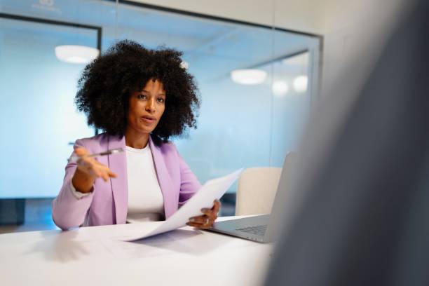 istock Black financial advisor guides her client through financial contract 2182113396