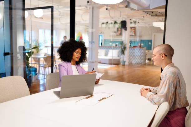 istock A woman explains how compound interest can help grow her client’s investments over time 2182113545