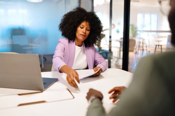 istock Female financial advisor guides her client through financial contract 2182113632