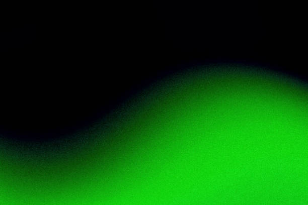 istock Grainy glowing neon green wave abstract divided wavy pattern black background with blank space 2182114001