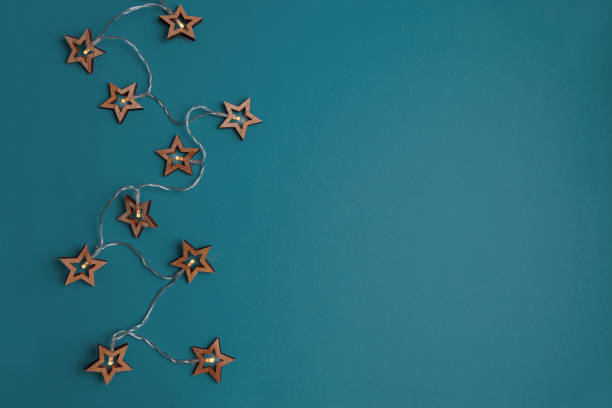 istock Christmas holidays background with Christmas lights on blue background. Top view 2182114591