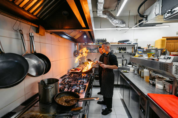 istock Chef And Sous-Chef Cooking With Fire In A Commercial Kitchen 2182117869