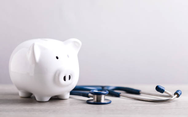 istock A white piggy bank and a stethoscope rest on a table against a bright white background. The image represents the concept of saving money for health care or financial security. 2182117934