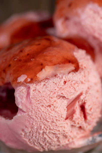 red strawberry-flavored ice cream in a glass bowl