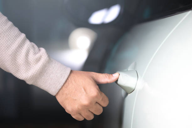 istock A man's hand touching the car door to unlock it without using a remote or key. Represents the concept of modern vehicle technology, highlighting keyless entry systems for convenience and security 2182119663