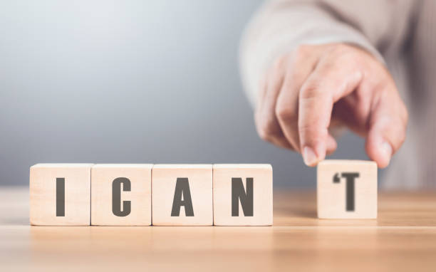istock Hand separates the letter T from the word I CAN'T transforming it into CAN The image symbolizes overcoming obstacles, shifting from doubt to empowerment, and embracing a positive mindset 2182120183