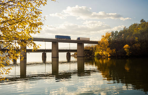 Trucks crossing the bridge.