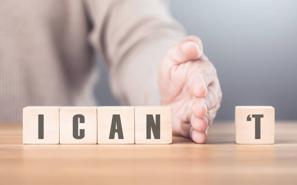istock Hand separates the letter T from the word I CAN'T transforming it into CAN The image symbolizes overcoming obstacles, shifting from doubt to empowerment, and embracing a positive mindset 2182120222