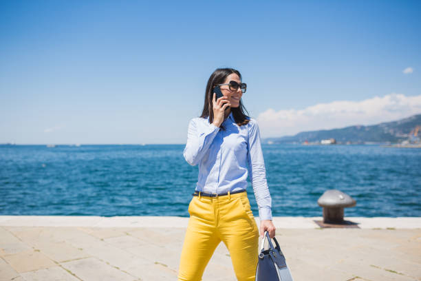 istock Seaside Stroll with Phone and Bag 2182120815