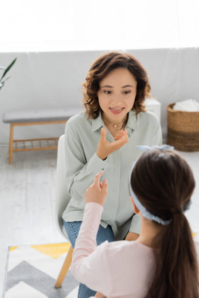 istock A speech therapist engages a child in a bright consultation room 2182120840