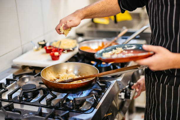 istock Young Chef Cooking With A Pan In A Commercial Kitchen 2182120853