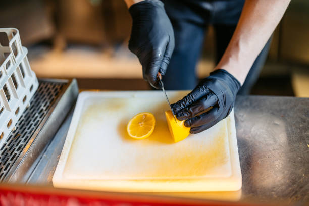 istock Bartender Cutting Lemons To Make A Lemonade At The Bar Counter 2182122627