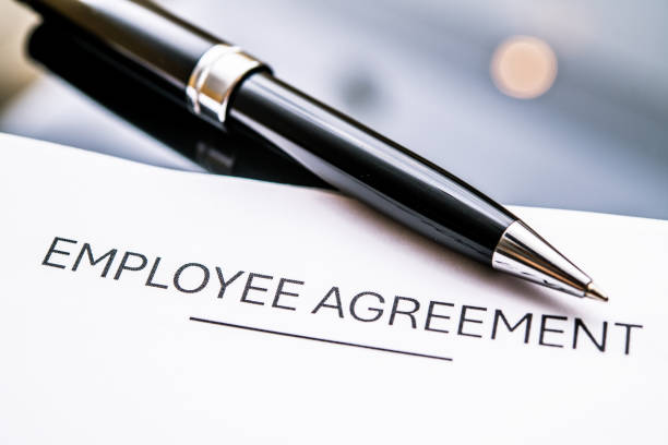 istock Close-Up of an Employee Agreement Document with a Pen, Representing Workplace Contracts, HR Policies, and Legal Obligations in Professional Settings 2182124707
