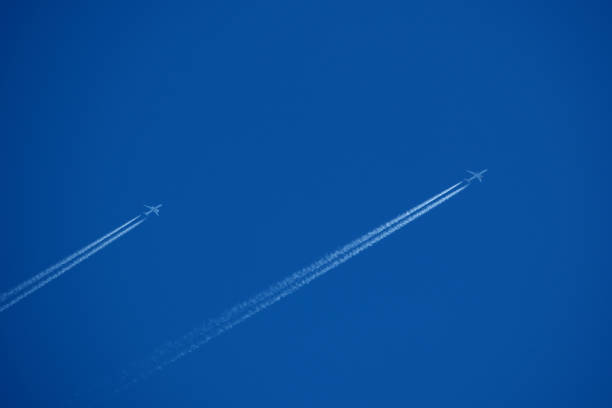 Airplane trails in the blue sky, contrails.