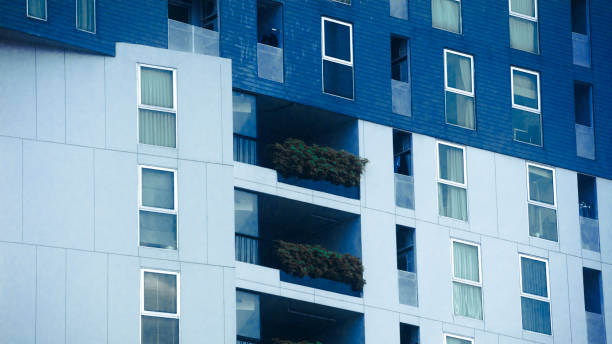 istock Trees in facade of apartment building 2182125179