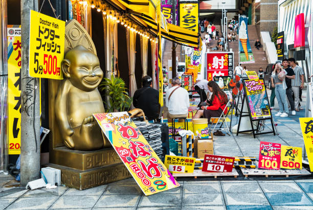 Osaka, Japan - 05.05.2024: Busy crowded pedestrian street in Shinsekai district. Tourist attraction in Osaka
