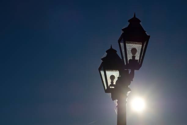A retro-style lamppost illuminated by the sun.