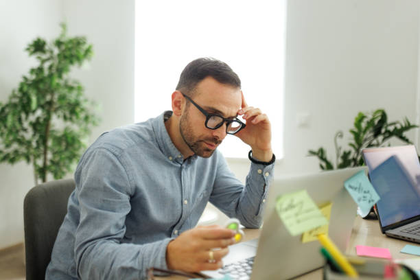 istock Young well dressed businessman working at office, using fidget spinner for stress relief 2182134338