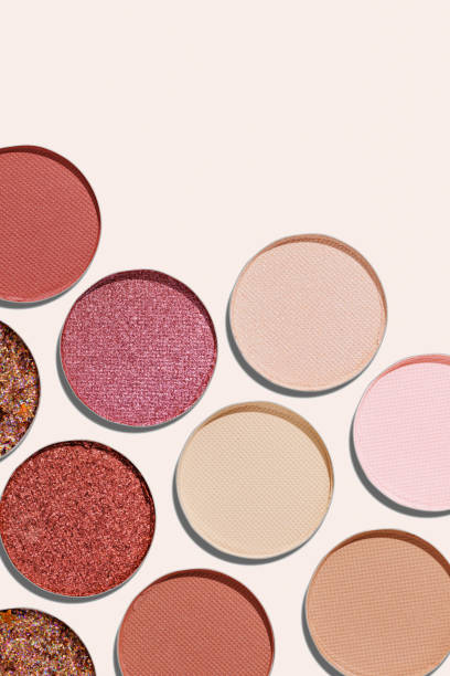 istock Colorful Swatches eyeshadow refills as minimal geometric pattern. Matte, glitter pans red brown pink shade with sun shadows, detailed texture, cosmetic, beauty product, makeup, warm color scheme 2182135321